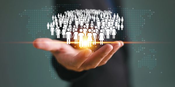 A hand with figures of people to represent a team