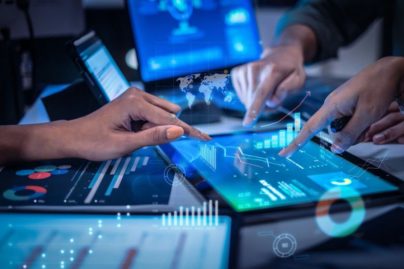 close up hand team of financial discussion fintech  technology planning, analyzing digital financial data and strategy in a modern office at night