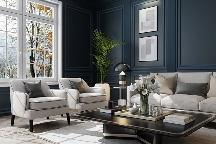 Elegant living room with dark blue walls, white furniture, and a large window.