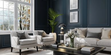 Elegant living room with gray furniture and dark blue walls.