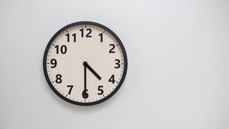 Classic Black-Edged Clock on White Background at 16.30 or 04.30 - Perfect for Time Management and Text Space