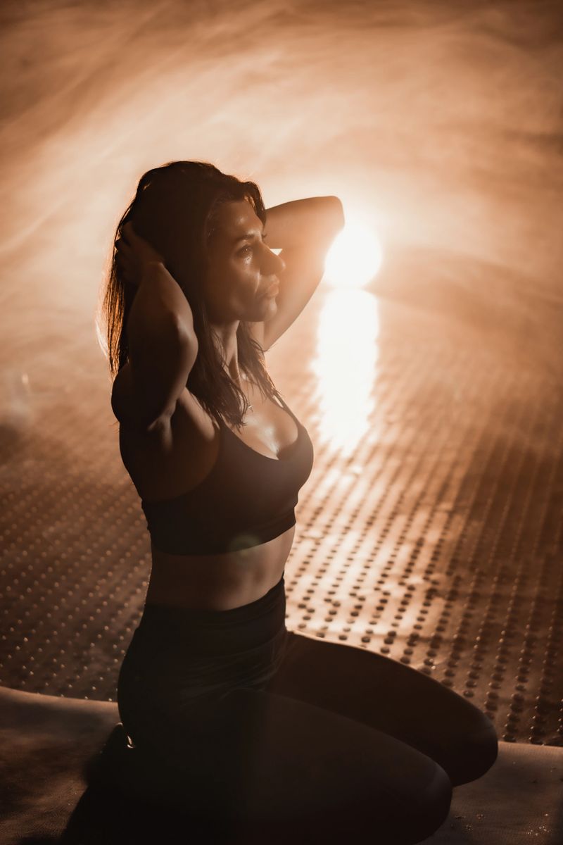 In a misty outdoor setting, a confident woman in stylish athletic wear strikes a pose, radiating strength and elegance, inspiring others to embrace fitness, healthy living, and mindfulness