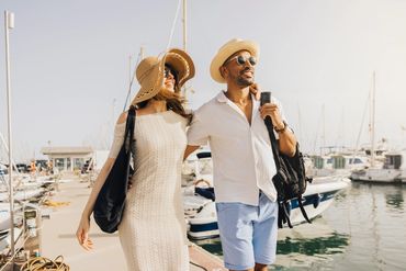 Couple enjoying a sunny day walk at the marina.