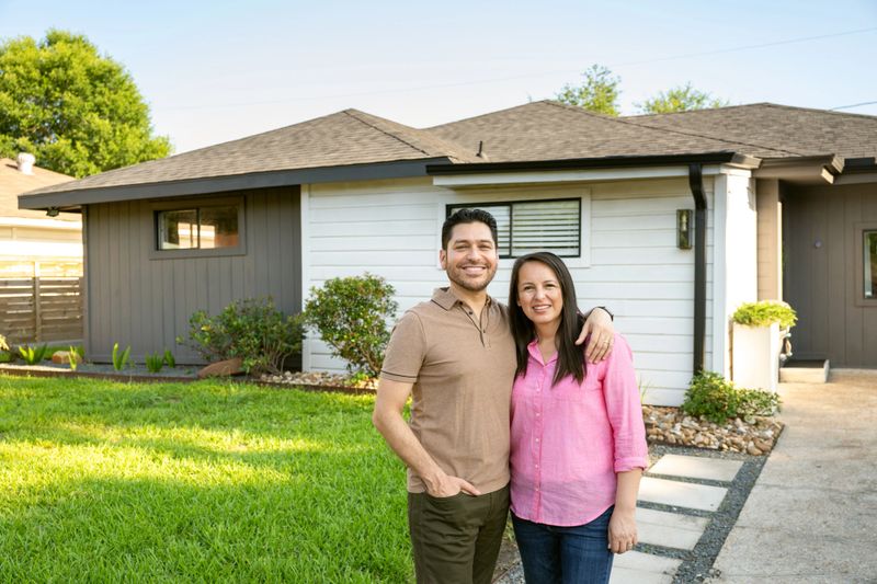 Mature couple portrait in front of their home in Texas