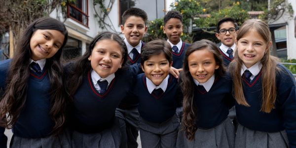 Group of smiling schoolchildren in uniform.