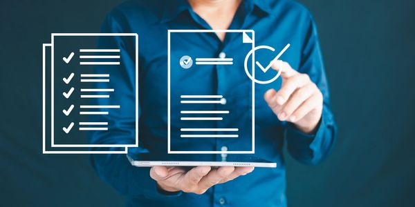 Person holding a tablet with digital checklists and checkmarks.