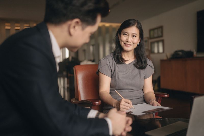 Business partners discuss commercial deal, contract details at formal meeting