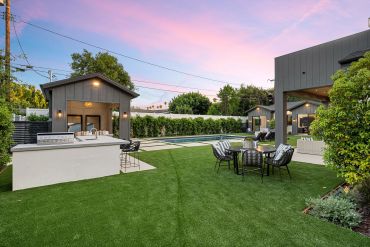Modern backyard with a small house and pool.