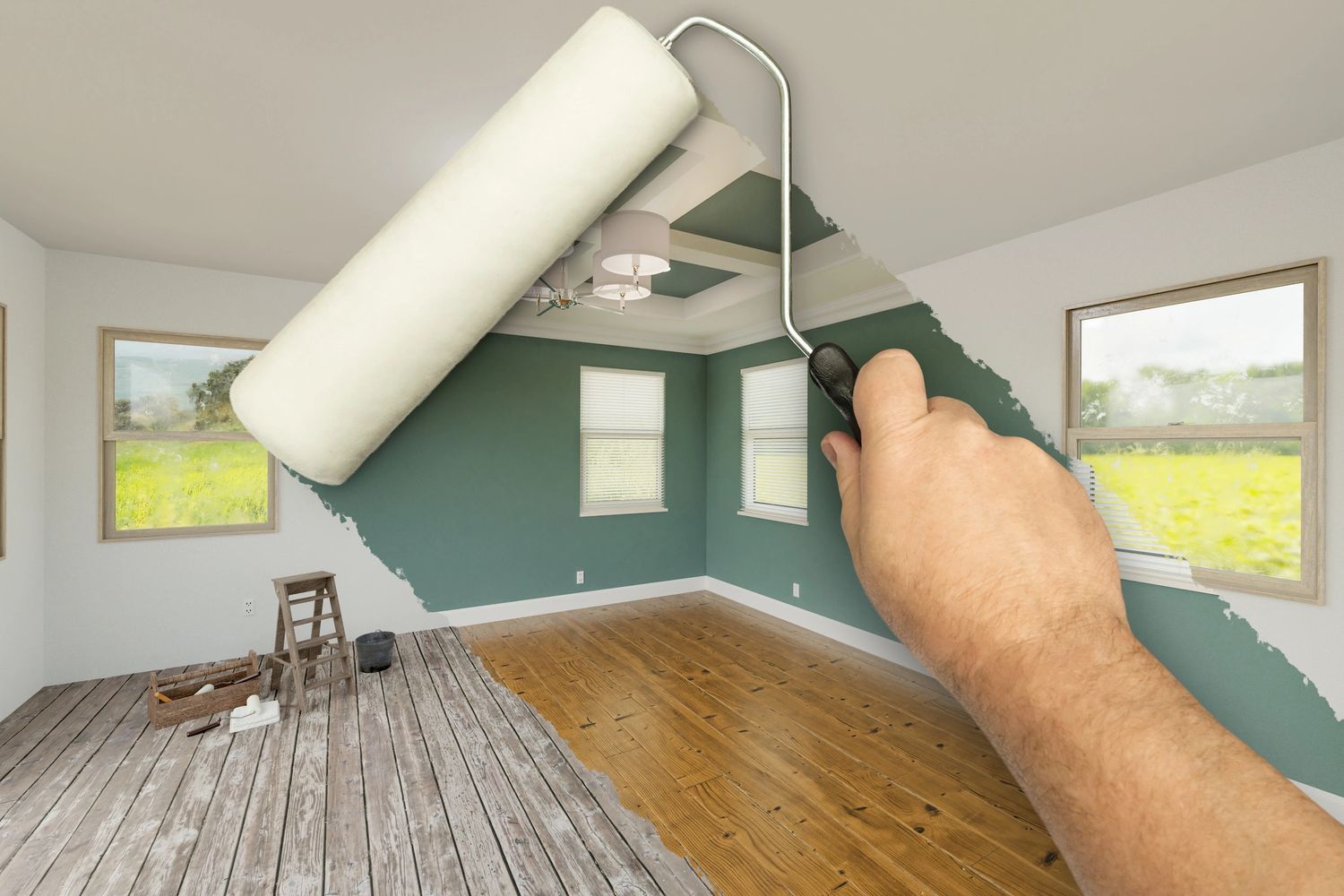 A hand painting a green wall white with a roller in a bright room.
