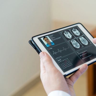 Person interacting with a digital healthcare interface on a tablet.