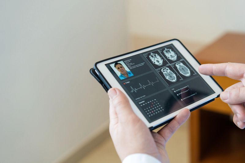 Doctor reviewing x-ray images on a digital tablet in clinic. Healthcare professional using digital tablet to check the medical record of a patient in hospital.