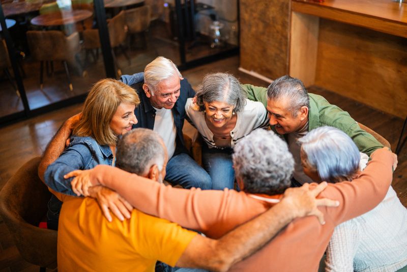 Senior patients embracing during group therapy session