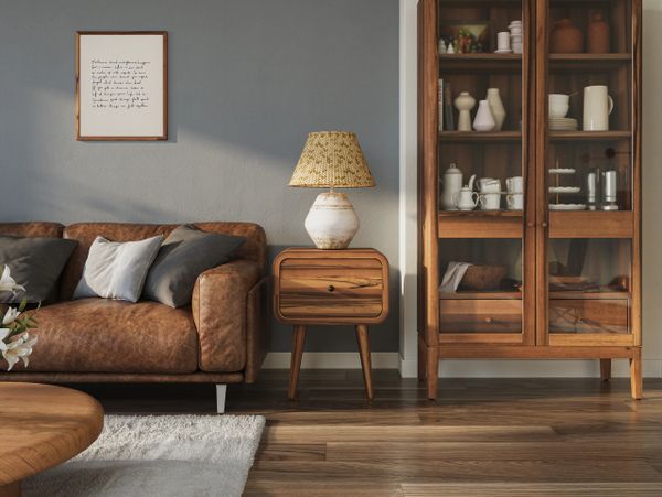 Cozy living room with brown leather sofa and wooden furniture.
