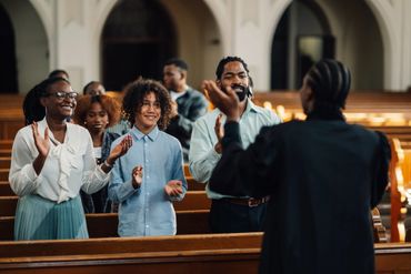 People joyfully singing together in a church setting.
