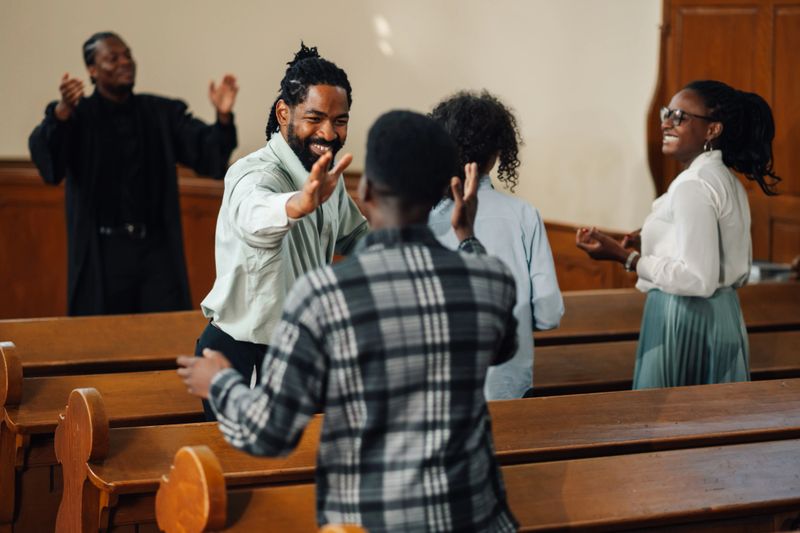Diverse group of people celebrating their faith in a beautiful church, singing songs of praise and praying together, united in spirituality and love for god and jesus
