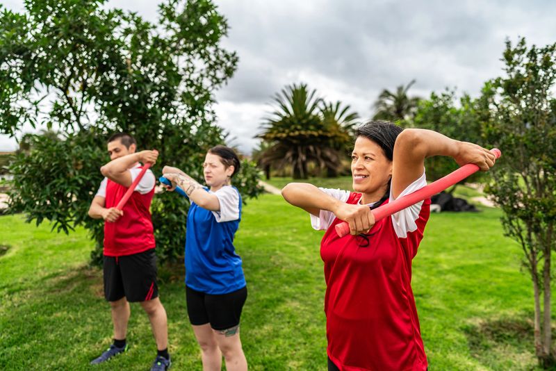 Friends practicing escrima in a public park