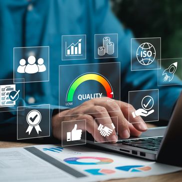 Businessman using laptop with virtual quality control icons.