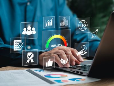 man working on laptop with icons for quality overlaying the image