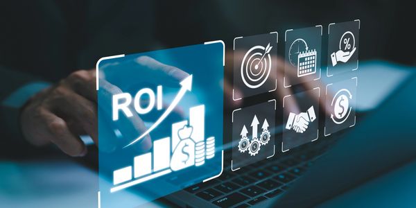 Digital interface showing ROI growth and financial icons above a laptop keyboard.
