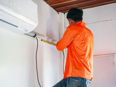 alt="Installing ductless A/C unit in Toronto condo"