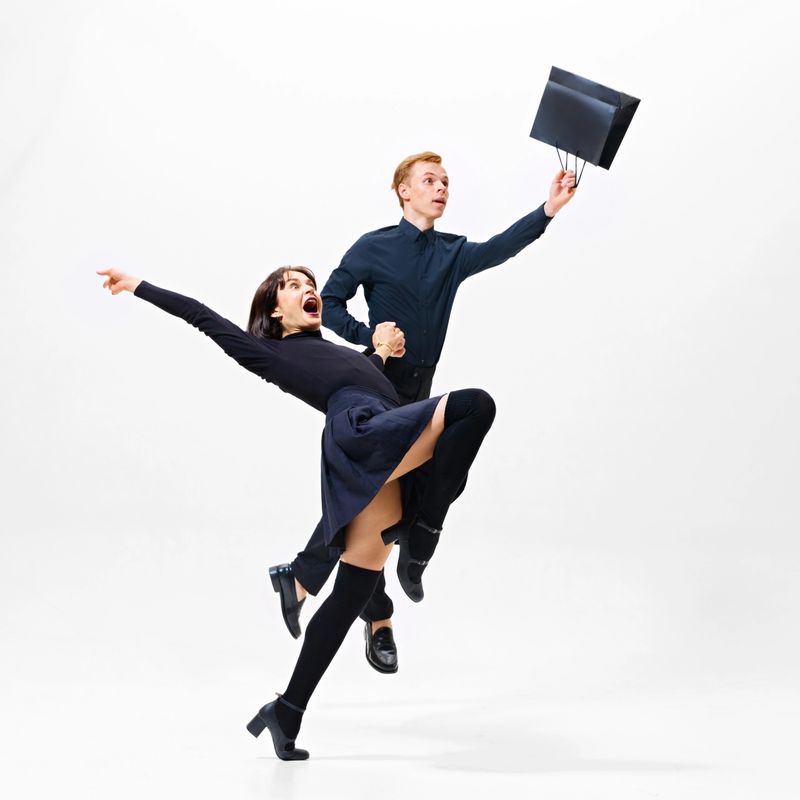 Graceful and stylish man and woman in motion on shopping journey, with bags in hand, excitement leading the way. Concept of shopping, sales, Black Friday, fashion, holiday