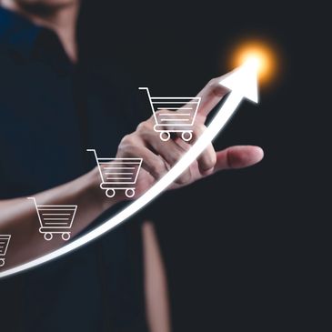 Person pointing at a rising arrow with shopping carts, symbolizing e-commerce growth.