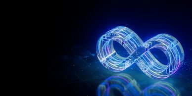 A glowing blue infinity symbol on a dark reflective surface.
