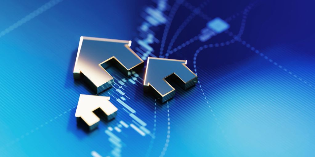 Metallic house icons on a digital financial chart background.