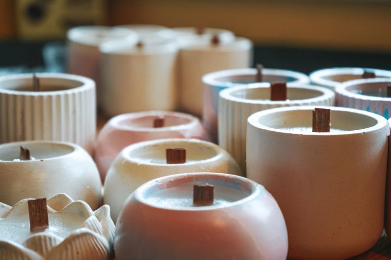 Ecological and vegan business. Soy candles poured into recycled bottles and jars. Many soy wax candles together on store or workshop background