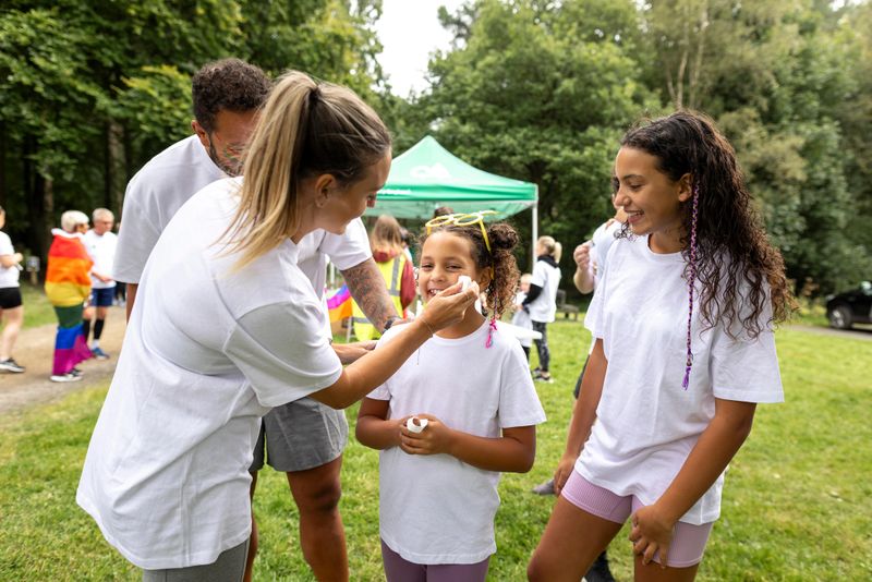 Three-quarter-length shot of a real family preparing for an LGBTQIA pride colour run. The scene is filled with happiness, inclusivity, and community spirit, with people gathering in the background. They are located in Northumberland, England.

Videos are available similar to this Scenario.