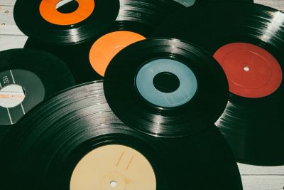 Collection of vinyl records with colorful labels.