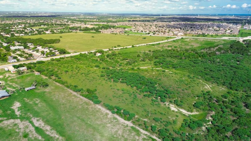 Large vacant land near new development residential neighborhood houses in New Braunfels, suburbs San Antonio, master planned community to grow along Rueckle Road and Morningside Drive, aerial. USA