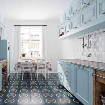 Bright kitchen with pastel blue cabinets and patterned floor tiles.