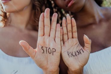 Hands showing message to stop racism.