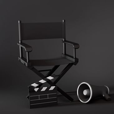 Black director's chair with clapperboard and megaphone.