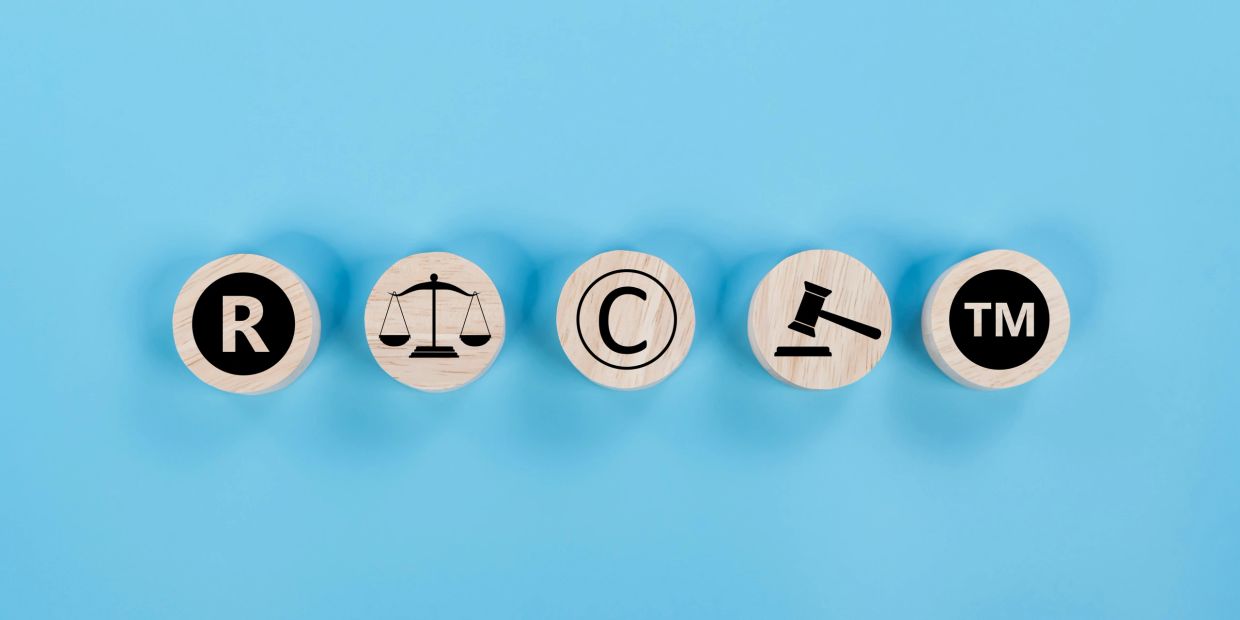 Legal symbols on wooden blocks against blue background.