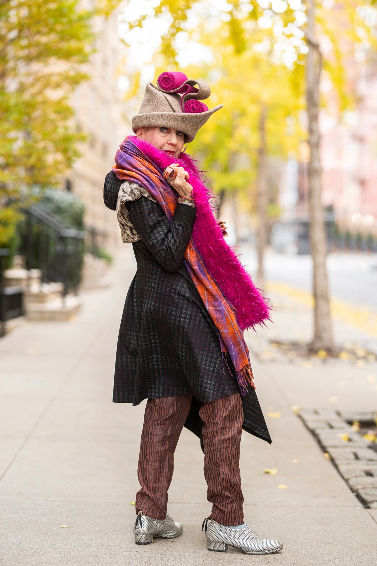 Model lounges in beige outfit and patterned scarf for Marko Stout's After Dark Collection at New York Fashion Week.