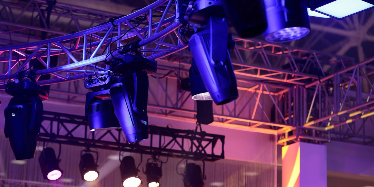 Stage lighting fixtures hanging from trusses.