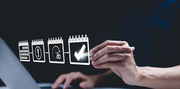 Person interacting with digital task icons above a laptop, symbolizing productivity and workflow.