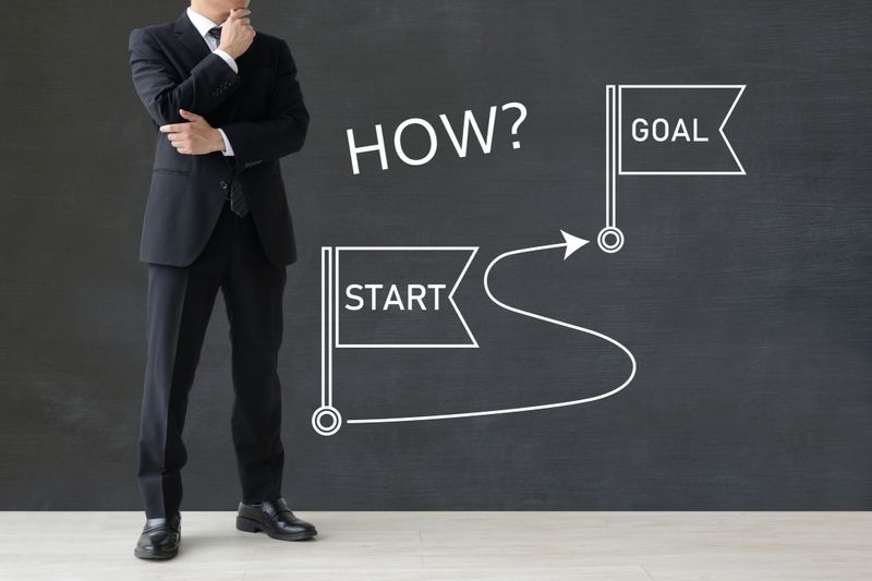 Business man thinking about path from start to finish