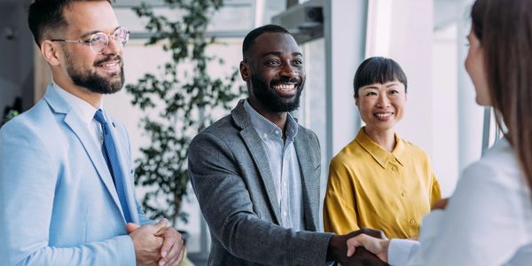 deal_shake_hands_black_man_asian_woman_deal_clientele_strong_positive_referrals_personal_Introduce