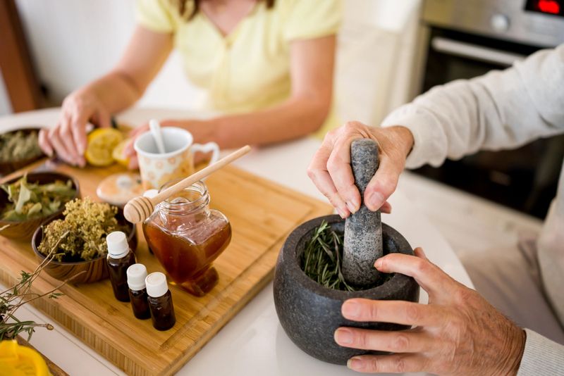 High angle shot of unrecognizable senior couple making herbal tea, healthy drink for better immunity and tinctures at home