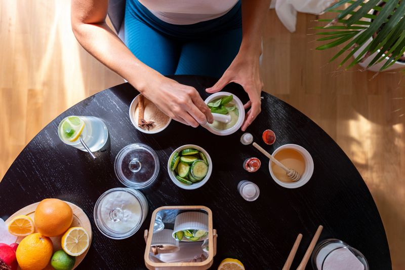 A young woman carefully combines ingredients, prepares a natural mask for skin care.
