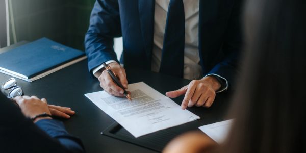 Businessman signing a document at a meeting.