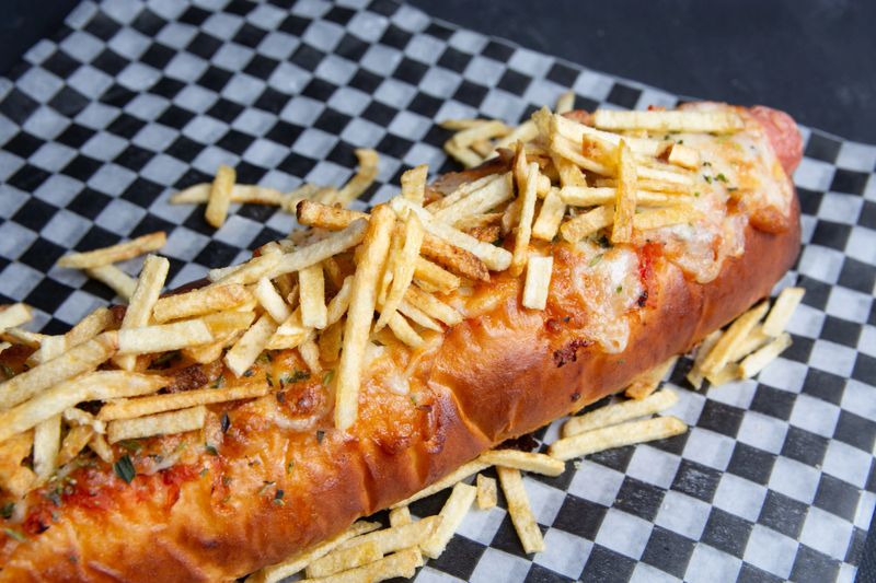 hot dog with fries in a wrapper for delivery