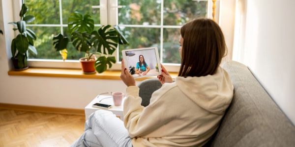 Person holding a tablet for video chatting.