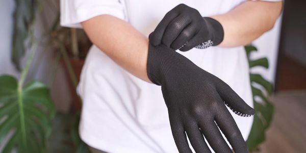 Person wearing new black gloves