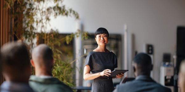 A woman giving a presentation to an audience.