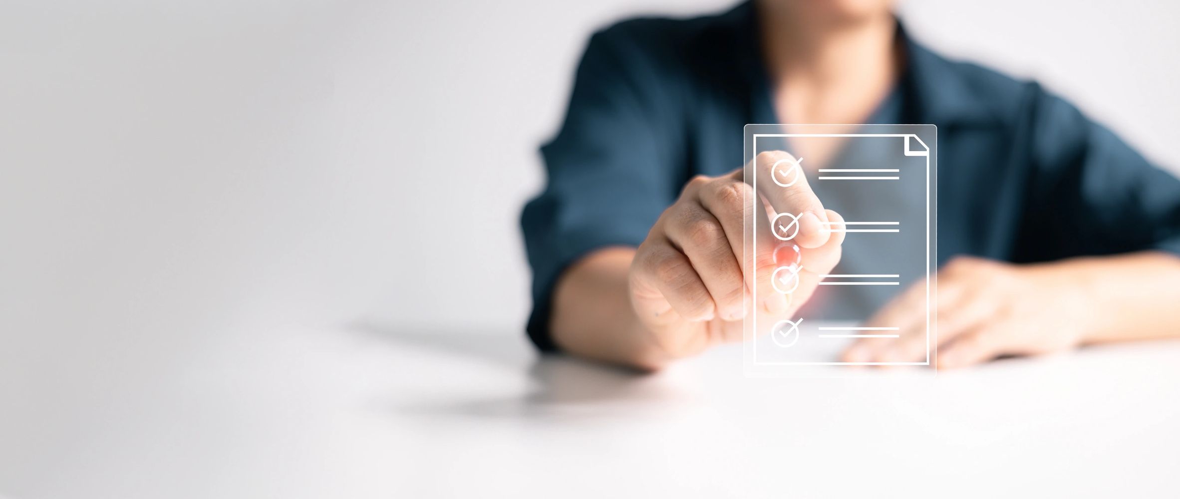Person marking a virtual checklist on a transparent digital interface.