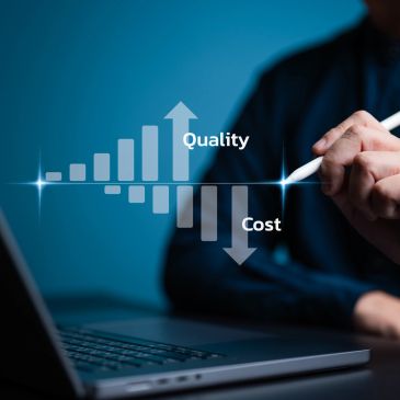 Person illustrates rising quality and decreasing cost on a virtual graph above a laptop.